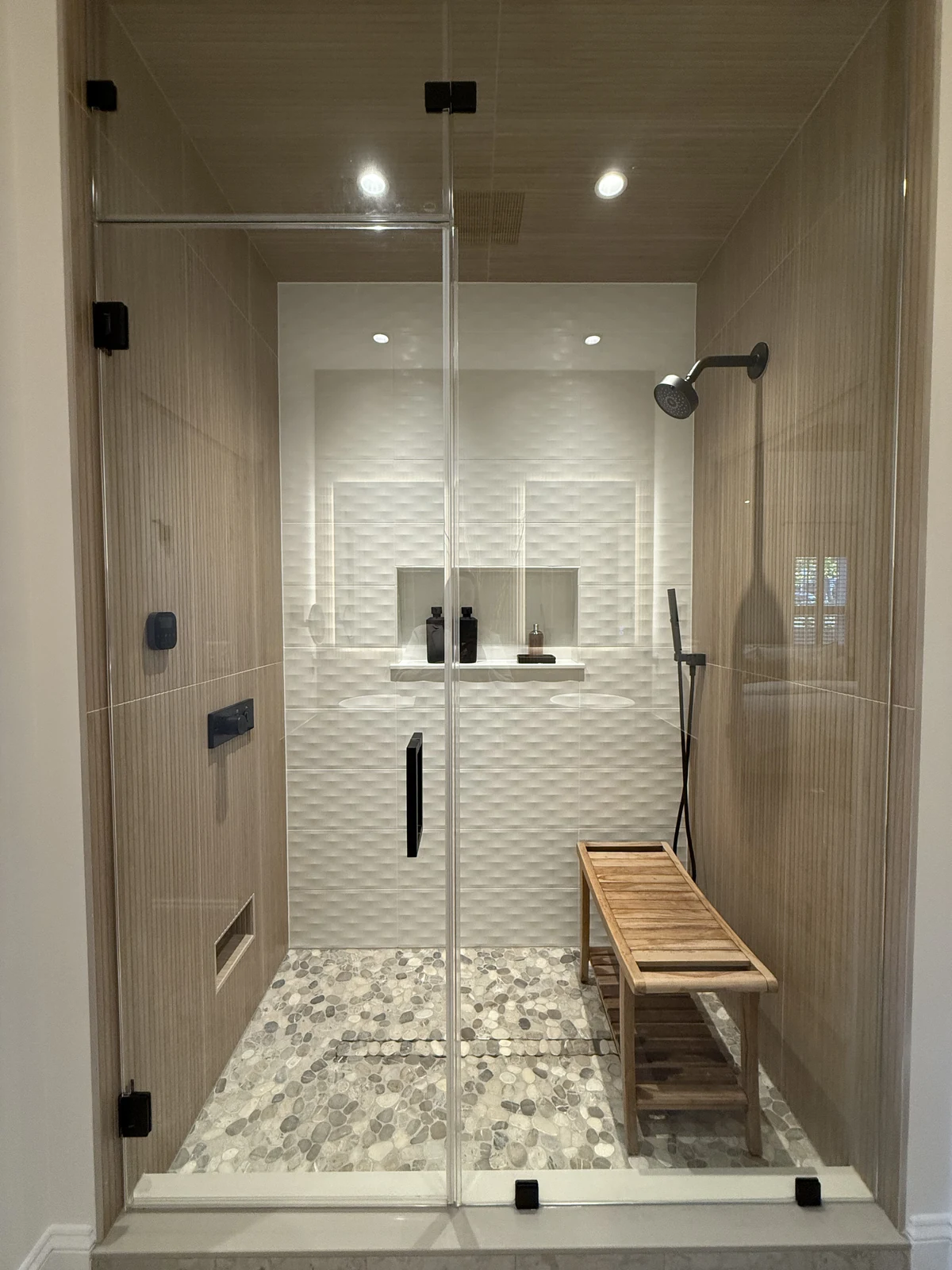 The Primary Suite Retreat tiled shower with bench